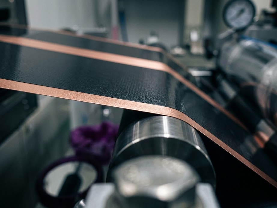 A coated electrode foil running over a roller on a battery coating line
